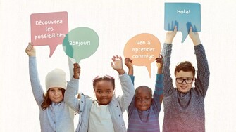 Kids hold up signs in the shape of speech bubbles that contain French and Spanish words and phrases.