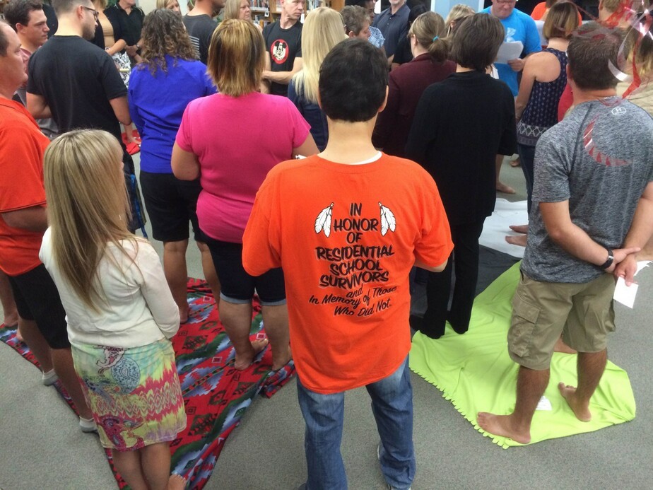 student with orange shirt