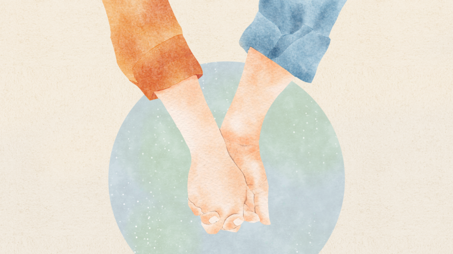 two hands holding each other in front of globe