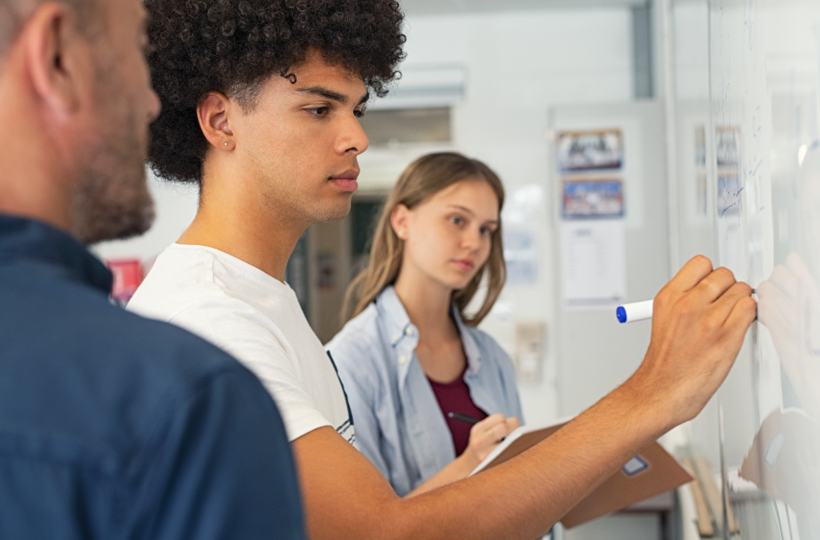 Teacher helping students work on math